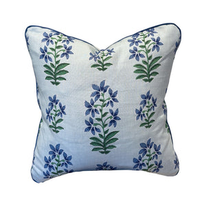 The Shani Blue Pillow by HIVE ALTERATIONS features a white background with blue and green floral patterns, crafted from premium materials to add a luxurious touch to your home décor.
