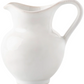The Juliska Puro Whitewash Dinnerware Collection features a white ceramic pitcher with a curved handle and wide spout, photographed on a white background, perfect for complementing any neutral décor.