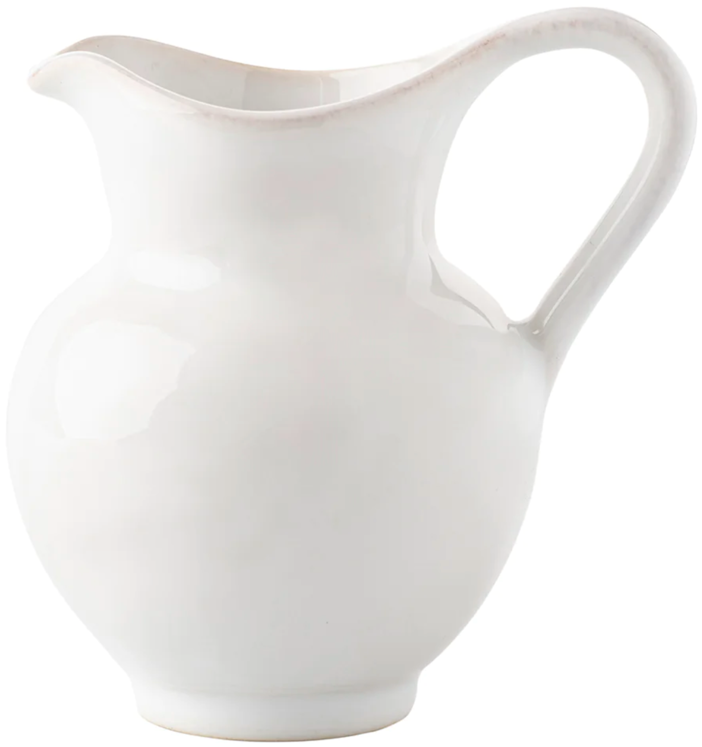 The Juliska Puro Whitewash Dinnerware Collection features a white ceramic pitcher with a curved handle and wide spout, photographed on a white background, perfect for complementing any neutral décor.