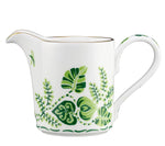 The Cobblers Cove Calypso Cream Pitcher by Royal Crown Derby features a handle and is adorned with vivid green leaf and fern patterns plus a slim gold rim—an elegant piece inspired by English fine bone china.