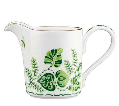 The Cobblers Cove Calypso Cream Pitcher by Royal Crown Derby features a handle and is adorned with vivid green leaf and fern patterns plus a slim gold rim—an elegant piece inspired by English fine bone china.