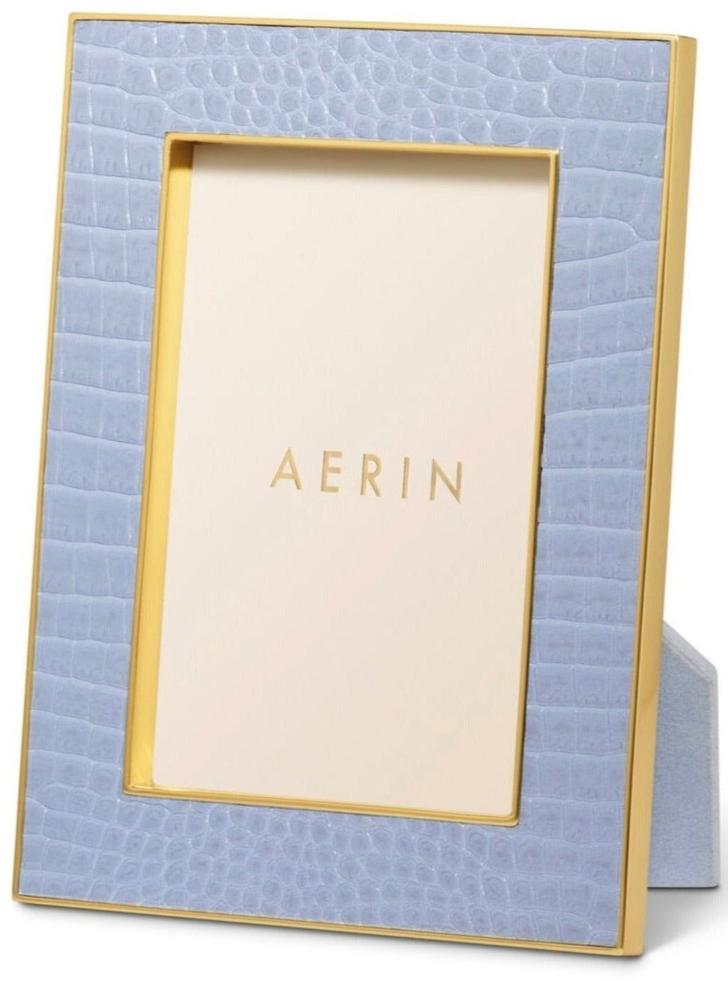 The Aerin Classic Croc Leather Frame Collection features a rectangular photo frame with light blue Italian croc-embossed leather, gold trim, and an upright stand. A card labeled "AERIN" is displayed in the empty space.