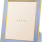 A square photo frame from the Classic Croc Leather Frame Collection by Aerin, featuring light blue Italian croc-embossed leather, gold trim, and a blank insert with "AERIN" in gold, shown at an angle.