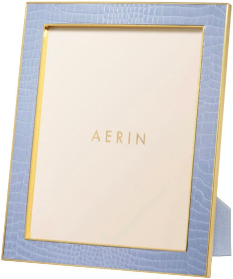 A square photo frame from the Classic Croc Leather Frame Collection by Aerin, featuring light blue Italian croc-embossed leather, gold trim, and a blank insert with "AERIN" in gold, shown at an angle.