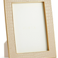 The Aerin Classic Croc Leather Frame Collection features a beige, Italian croc-embossed leather picture frame with gold trim, designed to stand upright and display your photos stylishly.