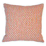 The Mandarin Wicker Outdoor Pillow by Associated Design features an orange and white geometric dot pattern, expertly crafted for a luxurious touch.