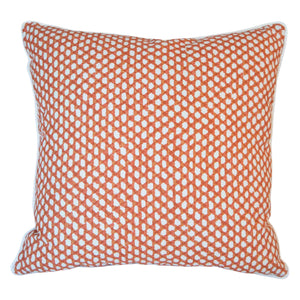 The Mandarin Wicker Outdoor Pillow by Associated Design features an orange and white geometric dot pattern, expertly crafted for a luxurious touch.