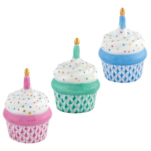 The Herend "Cupcake with Candle" features three hand-painted porcelain figurines with white frosting, colorful sprinkles, single candles, and pink, green, or blue scalloped wrappers—a charming artisanal accent for any decor.