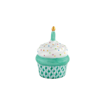 The Herend Cupcake with Candle is a hand-painted porcelain trinket box featuring a green base, white frosting with colorful dots, and a single candle—an artisanal decorative accent.