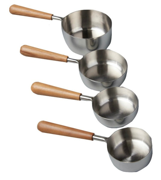 The Be Home Stainless Steel and Teak Measuring Cups, Set of 4, feature stainless steel cups with sustainably sourced teak wood handles, handcrafted in descending size order.