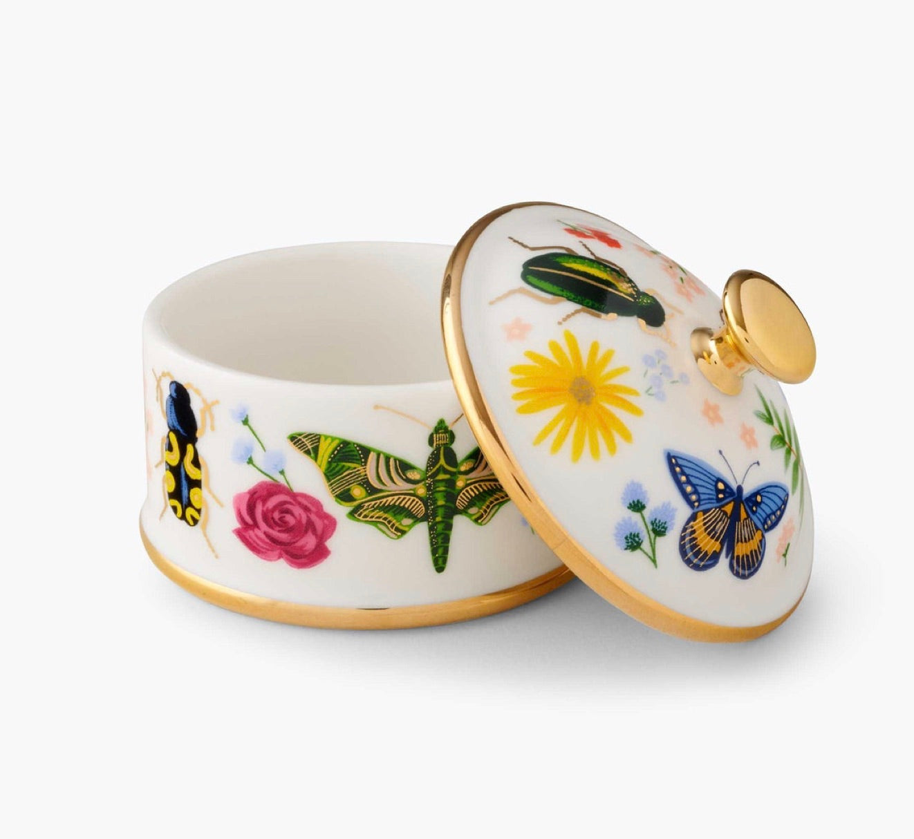 A porcelain box from the Curio Desk Accessory Collection by Rifle Paper Co., with a gold-rimmed lid ajar, features vibrant floral designs and whimsical bugs—a charming addition for garden enthusiasts.