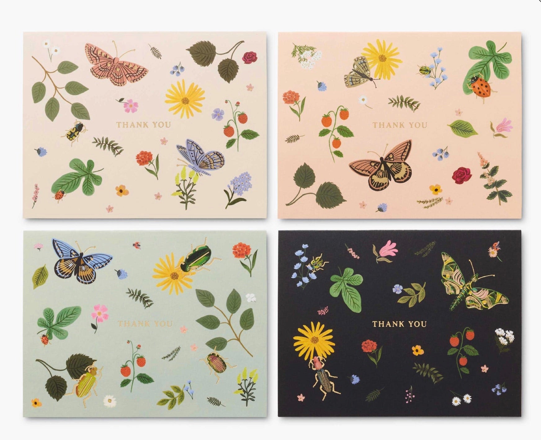 Set of four "Thank You" cards from the Curio Desk Accessory Collection by Rifle Paper Co., featuring botanical designs and illustrated bugs on beige, peach, light blue, and black—perfect for garden lovers.