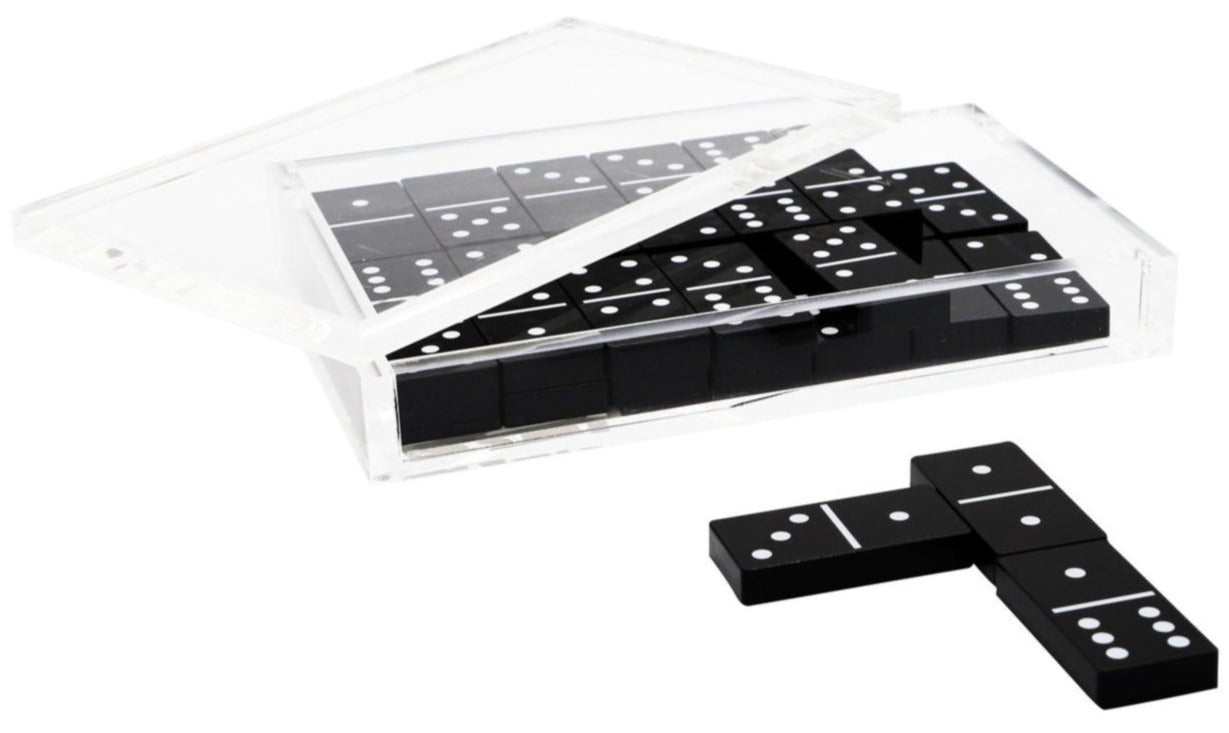 A set of Tizo Design's Tizo Lucite Domino Set Collection with white dots neatly packed inside an acrylic plastic case, with two domino pieces lying in front of the case.