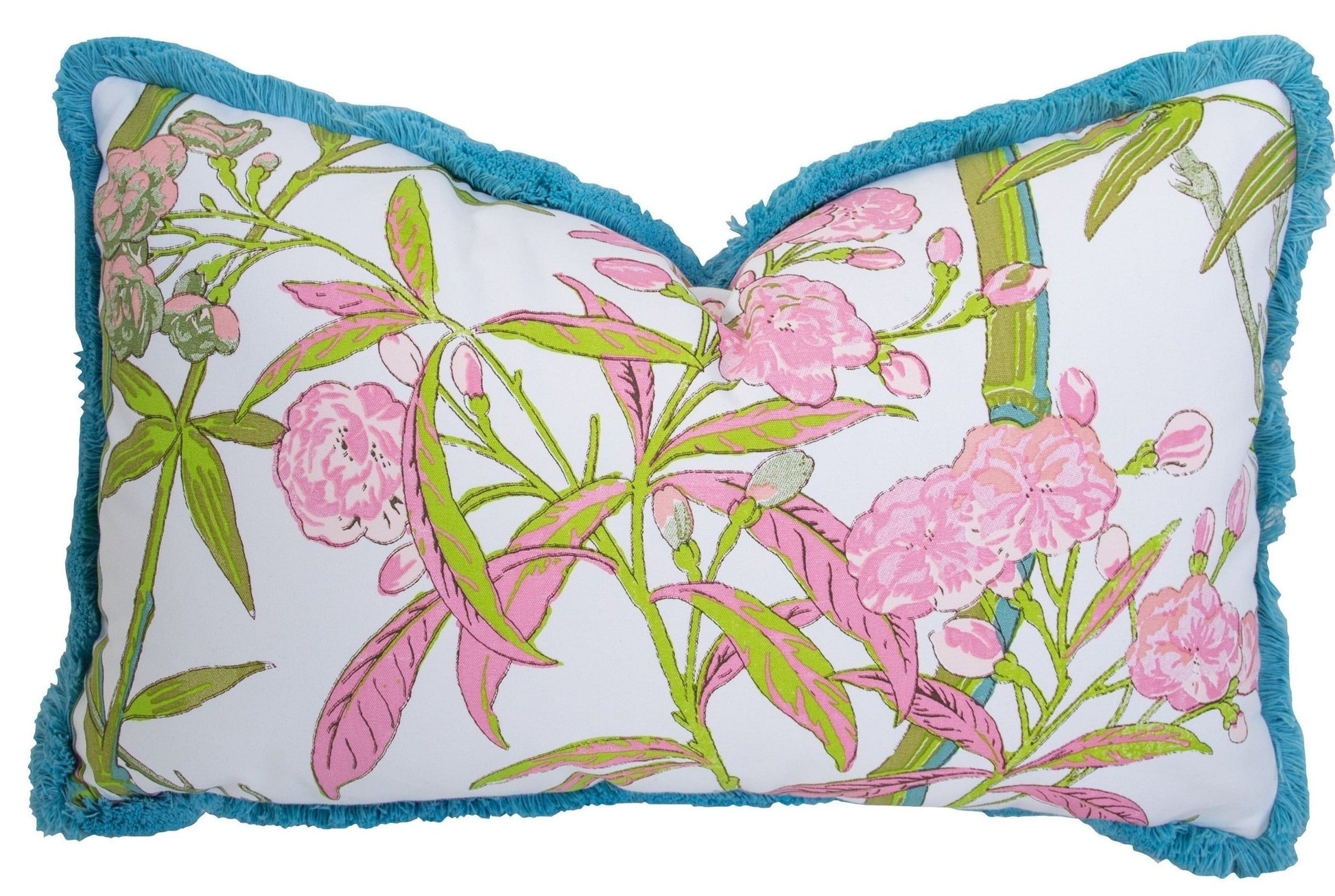 The Enchanted Garden Bamboo Outdoor Lumbar Pillow by Associated Design features a pink and green floral pattern on white with teal fringe trim. Handmade in the USA and filled with custom-poly for lasting comfort and style.