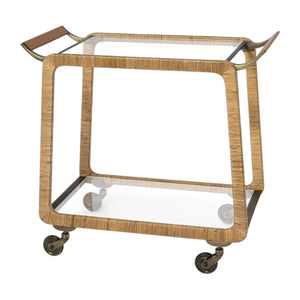 The PALECEK Woodford Bar Cart features a rectangular gold and glass design with a glass shelf, curved handles, brass-finished hardware, and four caster wheels.