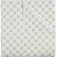 The Layla Bedding Collection by John Robshaw features a folded white quilt adorned with a repeating green geometric pattern inspired by Mughal gardens; the image displays both the front and a corner turned up to showcase the cotton voile backing.