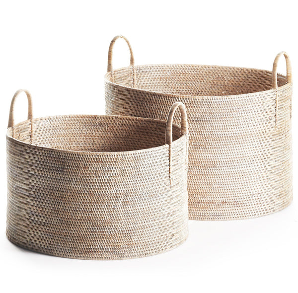 Two Napa Home Burma Whitewash Rattan Hampers by Napa Home & Garden, showcasing Burmese artistry with a tight weave and handles, come in a set of two woven round baskets, one slightly larger than the other, set against a white background.