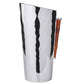From ezrad’s Bamboo and Stainless Steel Decor Collection, this tall stainless steel pitcher features a hammered texture and a right-side bamboo handle, offering a touch of modern elegance.