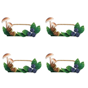 The Juliska Forest Walk Tabletop Collection features four identical frames with mushrooms, blueberries, green leaves, and gold rope accents—ideal as unique place card holders for your next gathering.