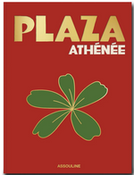 Cover of a red book titled "Plaza Athenee" with a gold and white font. The cover features a green leaf illustration and "Assouline" at the bottom, highlighting the essence of French hospitality and the culinary touch of Jean Imbert.