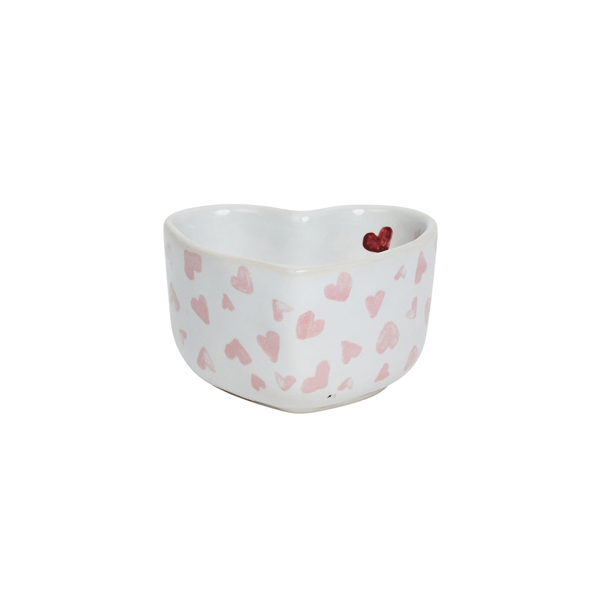 The Love You More Decor and Tabletop Collection by Juliska features a white ceramic heart-shaped bowl adorned with pink hearts and a small red heart inside.