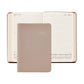 A beige 2027 Daily Journal by Graphic Image with a textured cover is placed on top of an open diary, showing entries for July 12 and July 13.