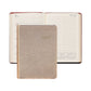 A closed Graphic Image 2027 Daily Journal with a metallic cover is displayed in front of an open appointment book that shows lined pages and a monthly calendar section.