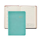 A turquoise 2027 Daily Journal from Graphic Image, featuring elegant gold lettering and ideal for use as an appointment book or diary, is pictured resting atop an open planner that reveals dated pages with lined sections and mini calendars.