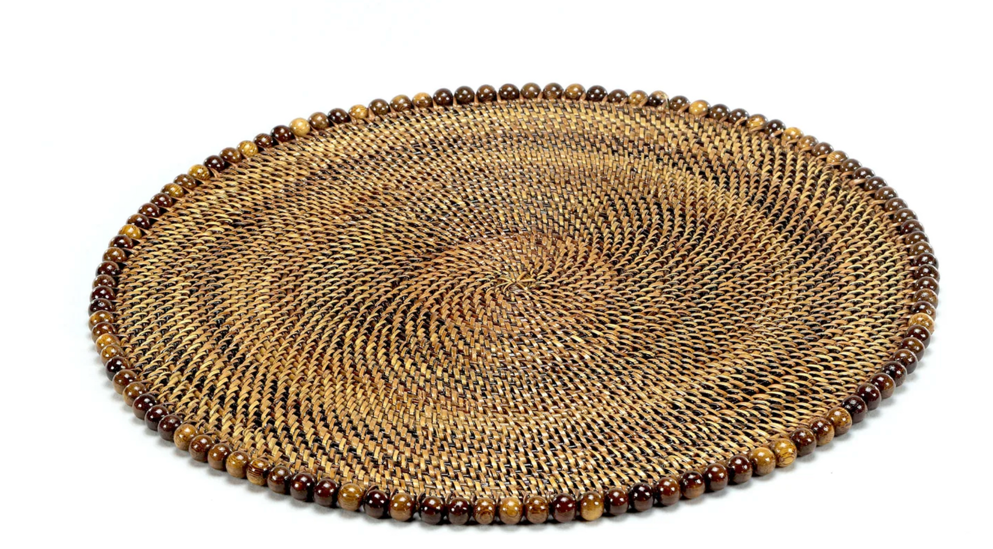 The Calaisio Round Placemat is handcrafted from natural vines and features a decorative border with alternating brown and tan beads, shown on a white background.