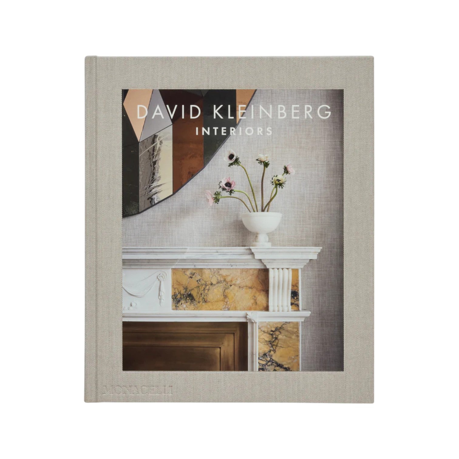 The cover of "Interiors" by Phaidon features a luxurious home with a decorative mantle, a vase of flowers, and abstract art above, reflecting the essence of refined interior design.