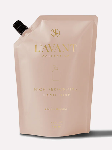 Blush-colored L’Avant Collective Blushed Bergamot hand soap refill pouch with a black cap and gold text.