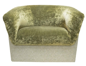 A green **Deco Rolled Arm Chair** by **LEE PARKER**, with a curved backrest and a textured, rectangular base, reminiscent of the sophisticated designs seen at the Kips Bay Show House.