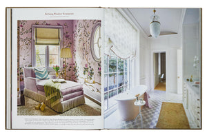 An open book, "**Decorate Like A Decorator**" from **Phaidon**, displays home interior design ideas with rooms featuring floral wall patterns, a pink armchair, a white bathtub near large windows, and various decor—all accompanied by expert decorating tips.