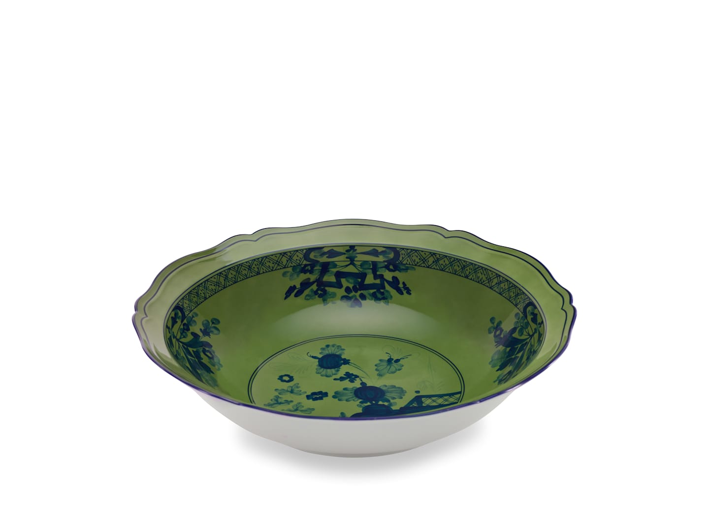 The Oriente Italiano Malachite Dinnerware & Decor Collection by Ginori 1735 features scalloped ceramic bowls with a green interior and blue floral patterns, inspired by exotic florals and Italian porcelain craftsmanship.