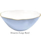 The Demeter Large Bowl from the Beatriz Ball Encanto Periwinkle Serveware Collection features a white enameled interior, pale blue exterior, scalloped gold-edged rim, and is crafted from durable aluminum alloy.