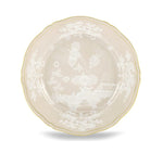 A round porcelain plate from Ginori 1735’s Oriente Italiano Meringa Dinnerware & Serveware Collection, featuring a scalloped edge, gold trim, and white floral and landscape patterns at the center and border.
