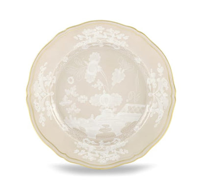 A round porcelain plate from Ginori 1735’s Oriente Italiano Meringa Dinnerware & Serveware Collection, featuring a scalloped edge, gold trim, and white floral and landscape patterns at the center and border.