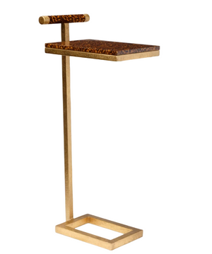 The Edgar Drinks Table by Made Goods features a gold metal frame, rectangular base, and a high gloss faux tortoise-patterned wooden top with a matching handle.