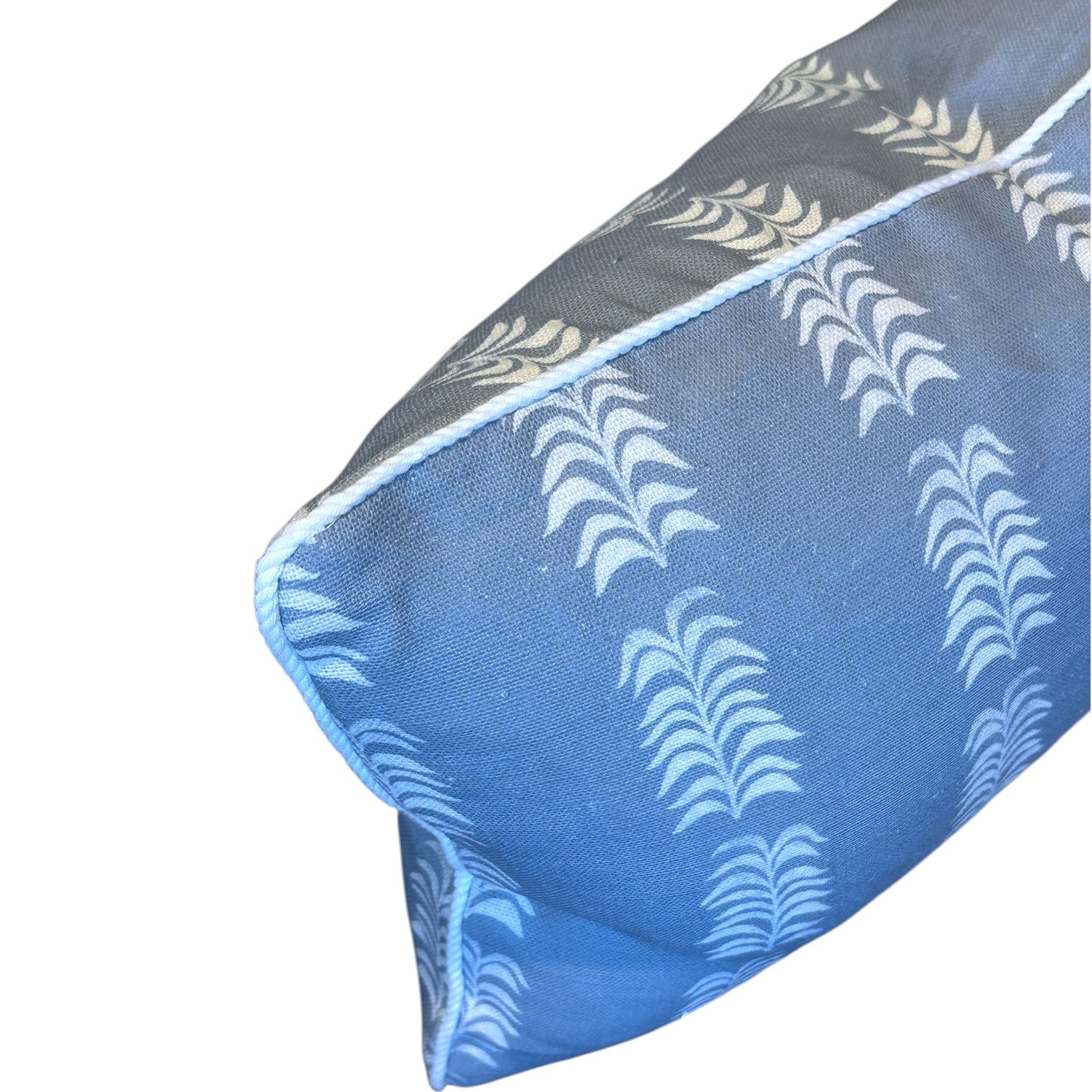 Close-up of the Hive Custom Pillows Petite Frond Blue Lumbar Pillow, featuring a white leaf pattern and white piping for an elegant, premium look.
