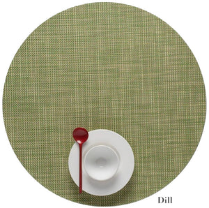 A white cup and saucer with a red spoon sit atop a green Chilewich Round Placemat, labeled "Dill" in the lower right corner and crafted from Terrastrand yarns.