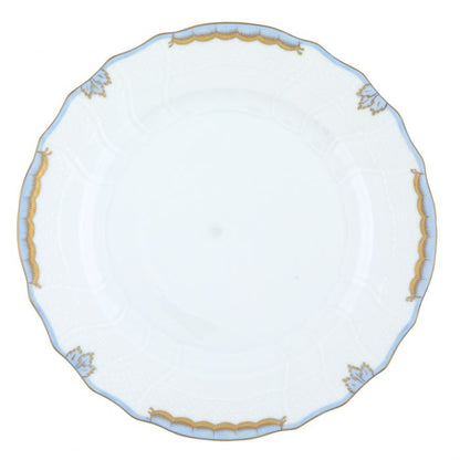 Herend’s Princess Victoria Light Blue Collection features a white porcelain plate with scalloped edges, gold trim, and delicate blue accents, echoing timeless elegance fit for royalty.