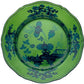 A decorative green plate with blue floral patterns and scalloped edges, viewed from above, from the Oriente Italiano Malachite Dinnerware Collection by Ginori 1735.
