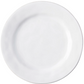 The Puro Whitewash Dinnerware Collection by Juliska features a plain, round, white ceramic plate photographed from above—an ideal neutral canvas for displaying teatime confections or savory tapas.