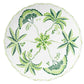 The Cobblers Cove Calypso Dinnerware Collection by Royal Crown Derby features a white ceramic plate with green palm trees and leafy patterns, bringing a refreshing Caribbean vibe to your table.