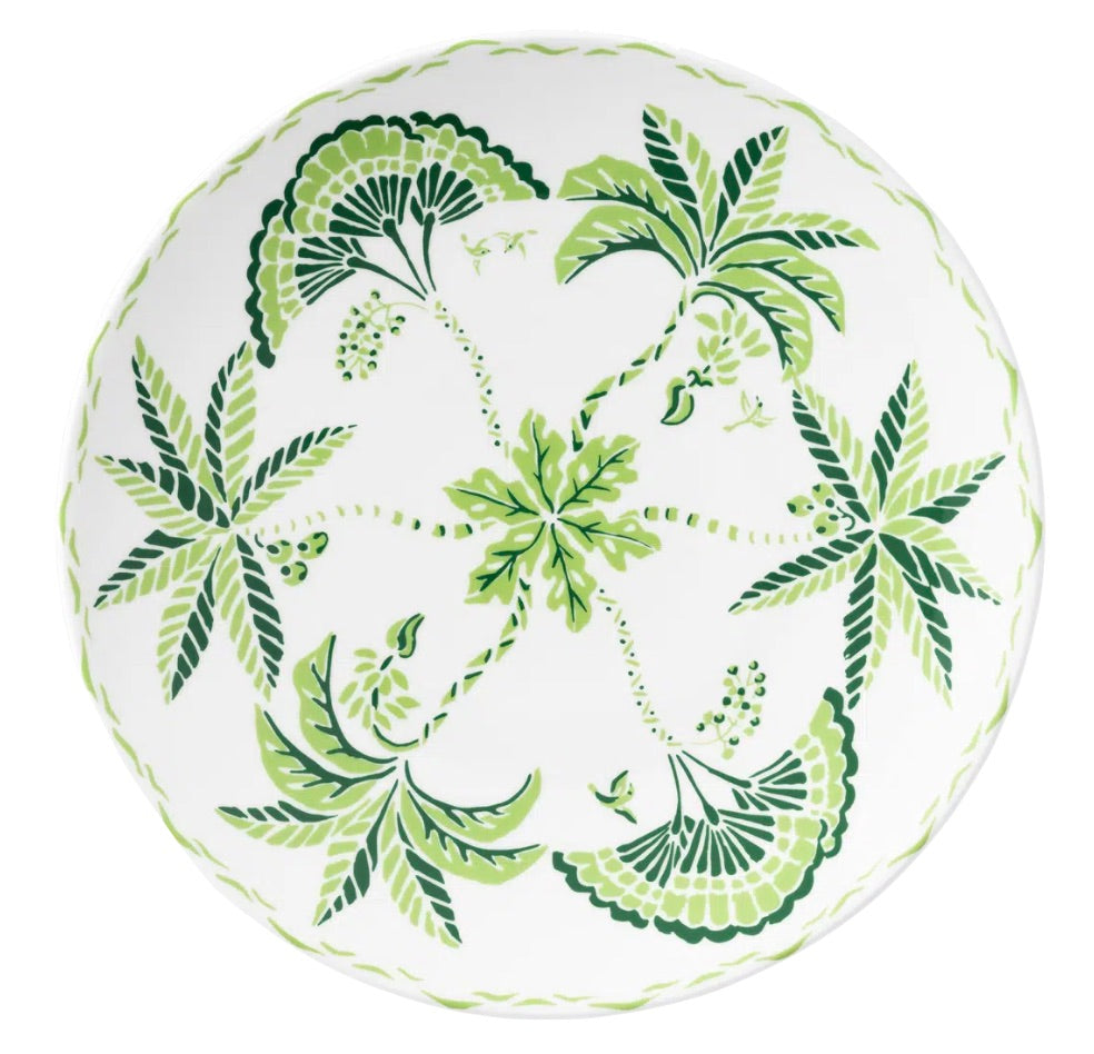 The Cobblers Cove Calypso Dinnerware Collection by Royal Crown Derby features a white ceramic plate with green palm trees and leafy patterns, bringing a refreshing Caribbean vibe to your table.