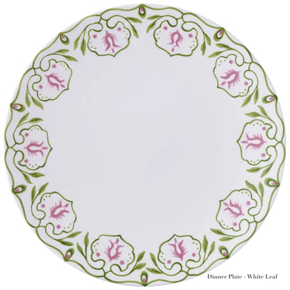 A round white fine bone china dinner plate from the Cobblers Cove Camelot Dinnerware Collection by Royal Crown Derby, featuring a green vine and pink flower rim. Labeled "Dinner Plate - White Leaf." Ideal for luxury boutique hotels.