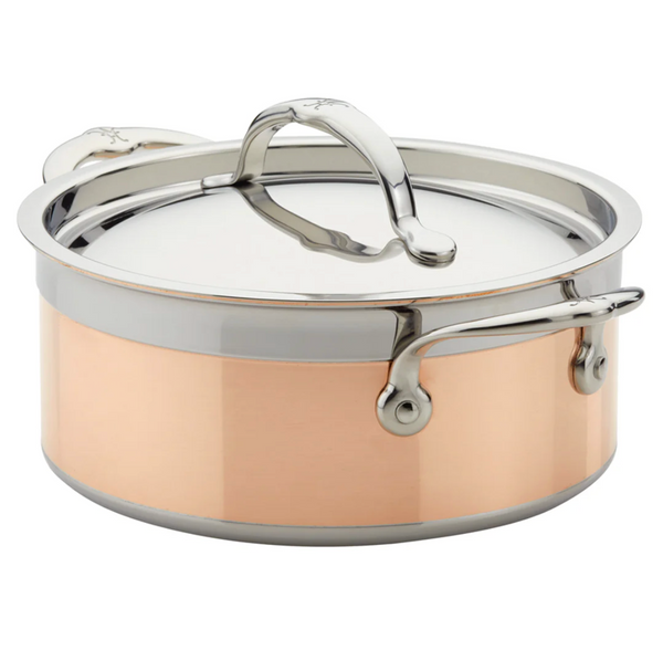 Hestan presents the CopperBond Copper Induction Soup Pot, 3qt, made of copper and stainless steel with a lid and handles, elegantly showcased on a white background.