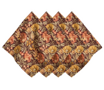 Five Willa Amber Napkins by Juliska, featuring a brown, orange, and gold floral motif with scalloped edges, are arranged in a fan shape to showcase their intricate autumn-themed design.