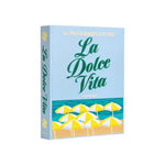 The La Dolce Vita Photo Album by PrintWorks features yellow and white beach umbrellas on a light blue cover—ideal for storing memories or displaying as decor.
