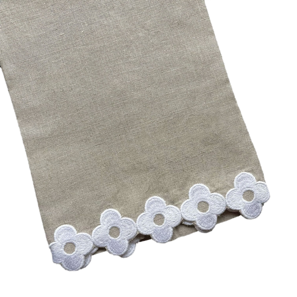 Dolly Tip Towel, Flax 100% linen fabric with a decorative border of white lace flowers, displayed on a black background by Haute Home.